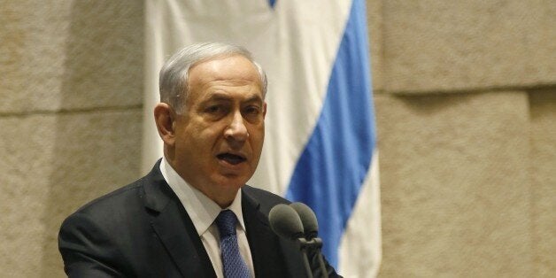 Israeli Prime Minister Benjamin Netanyahu delivers a speech at the Knesset, Israel's parliament, on October 29, 2014 in Jerusalem. An article published online by The Atlantic magazine quoted officials of US President Barack Obama's administration as calling Netanyahu a 'chickenshit' and attacking him over Israeli policy on settlement building in the occupied Palestinian territories. AFP PHOTO/GALI TIBBON (Photo credit should read GALI TIBBON/AFP/Getty Images)