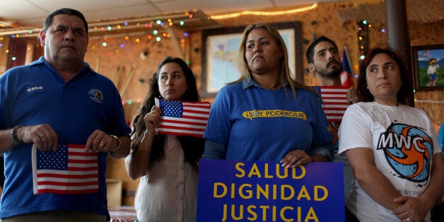 MIAMI, FL - FEBRUARY 17: People stand together as they hold a press conference to protest the district court judge in Brownsville, Texas, who issued a preliminary injunction that temporarily blocks the implementation process of President Barack Obama's Executive Action on immigration on February 17, 2015 in Miami, Florida. The immigration policy was planned to begin as soon as February 18, 2015, but with the injunction immigrant families will have to wait until the case is taken up by the 5th Circuit U.S. Court of Appeals. (Photo by Joe Raedle/Getty Images)