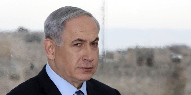 Backdropped by Jerusalem's Old City Ottoman walls, Israeli Prime Minister Benjamin Netanyahu looks on during a joint press conference with Jerusalem's mayor Nir Barkat (unseen) on February 23, 2015, a day after Barkat and his bodyguard apprehended a young Palestinian who stabbed an ultra-Orthodox Jew in Jerusalem. AFP PHOTO / GALI TIBBON (Photo credit should read GALI TIBBON/AFP/Getty Images)