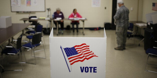 A voting booth stands at a polling station in the Kentucky National Guard Readiness Center in Burlington,...