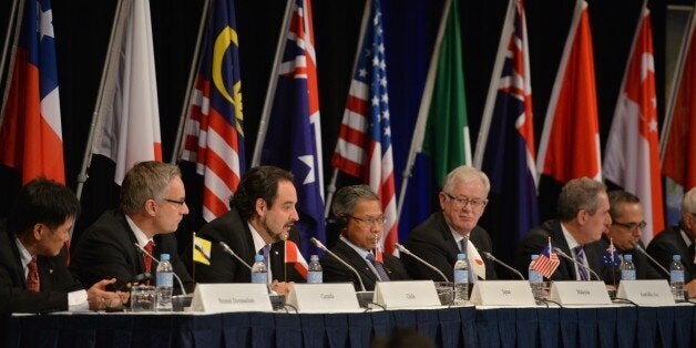 Trade representatives attend at a press conference for the Trans-Pacific Partnership (TPP), a pan-Pacific trade agreement by trade ministers from 12 nations in Sydney on October 27, 2014. The TPP, which would encompass 40 percent of the global economy and include 12 nations, has been the subject of negotiations for years. AFP PHOTO/Peter PARKS (Photo credit should read PETER PARKS/AFP/Getty Images)