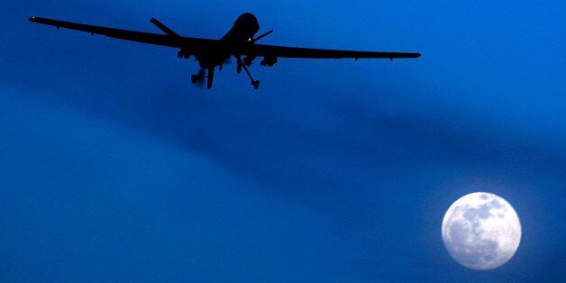 FILE - In this Jan. 31, 2010 file photo, an unmanned U.S. Predator drone flies over Kandahar Air Field, southern Afghanistan, on a moon-lit night. Amnesty International calls on the U.S. to investigate reported civilian casualties from CIA drone strikes in Pakistan and compensate victims in a report providing new details about innocent citizens allegedly killed in the attacks. (AP Photo/Kirsty Wigglesworth, File)