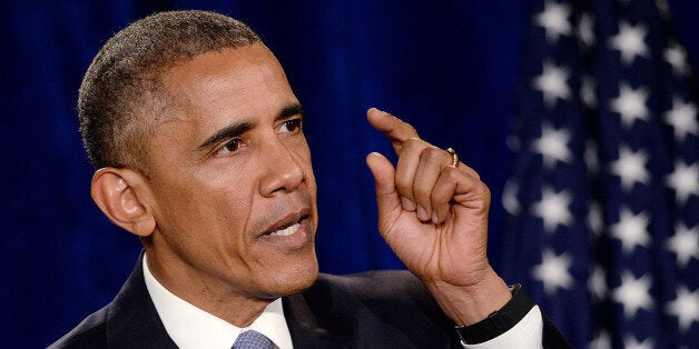WASHINGTON, DC - APRIL 23: (AFP-OUT) President Barack Obama speaks at an ''Organizing for Action'' dinner at the Ritz Carlton
