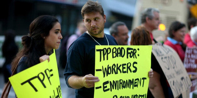 MIAMI, FL - MARCH 20: Union members and community activists protest outside the Miami Dade College where the Greater Miami Chamber of Commerce and the college were hosting a moderated conversation with U.S. Secretary of the Treasury Jacob Lew on March 20, 2015 in Miami, Florida. The protesters are against the Trans-Pacific Partnership (TPP) which is a proposed twelve-nation pact and are asking the Federal Government and Florida Congressional delegation to reject fast tracking the TPP and warn that the deal poses serious risk to jobs and wages, the environment, food safety and public health for Floridas working families. (Photo by Joe Raedle/Getty Images)