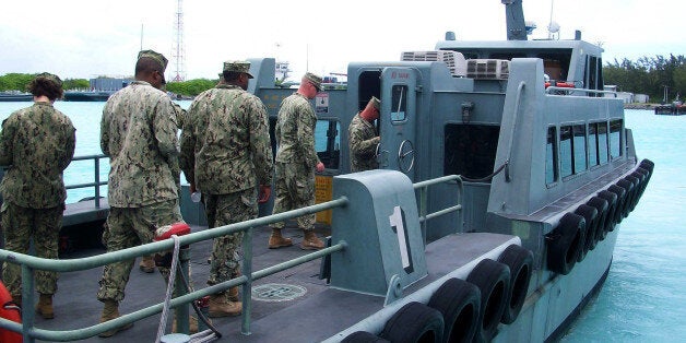 DIEGO GARCIA (Sep. 27, 2013) As part of familiarization training with local Maritime Prepositioned Forces, Seabees assigned to Naval Mobile Construction Battalion (NMCB) 3âs Diego Garcia detachment , board a harbor taxi enroute to a tour U.S. Naval Ship (USNS) SGT William R. Button. NMCB 3âs Diego Garcia team is tasked with building a 3,000 square-foot contractor living unit (CLU), which will serve as a residence for assigned civilian contractors. One of the first battalions commissioned during World War II, NMCB 3âs legacy stands strong in its ability to build and fight anywhere in the world as either a full battalion or as a group of autonomous detachments, simultaneously completing critical engineering and construction missions. For this deployment, NMCB 3 has split into nine details to perform critical construction projects in remote island areas such as Timor-Leste, Tonga, Cambodia and the Philippines. The teams will also conduct operations in Atsugi, Yokosuka and Okinawa, Japan; Chinhae, Republic of Korea and China Lake, Calif. The Naval Construction Force is a vital component of the U.S. Maritime Strategy. They provide deployable battalions capable of providing disaster preparation and recovery support, humanitarian assistance and combat operations support. NMCB 3 provides combatant commanders and Navy component commanders with combat-ready warfighters capable of general engineering, construction and limited combat engineering across the full range of military operations. (U.S. Navy photo by Equipment Operator 2nd Class Daanen M. Grasso/RELEASED).