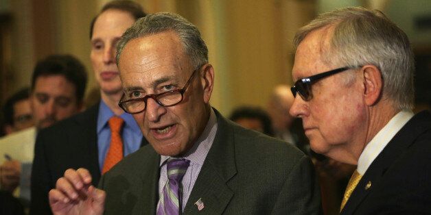 WASHINGTON, DC - MAY 12: U.S. Sen. Charles Schumer (D-NY) speaks to members of the media as Sen. Ron Wyden (D-OR) (L), and Senate Minority Leader Sen. Harry Reid (D-NV) (R) listen after the weekly Senate Democratic Policy Luncheon May 12, 2015 on Capitol Hill in Washington, DC. The Democrats held the weekly luncheon to discuss Democratic agenda. (Photo by Alex Wong/Getty Images)