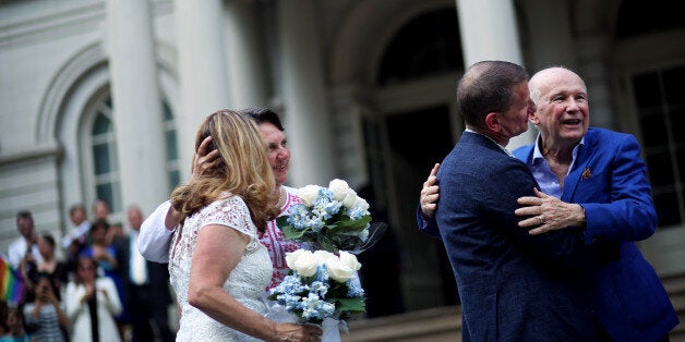 NEW YORK, NY - JUNE 26: (L-R) Cindy Jackson, a science teacher at Grace Church High School, and her partner, Denise Niewinski, Deputy Director of LGBTQ Policy and Practice at ACS, alongside Thomas Kirdahy, producer, and his partner, Terrence McNally, playwright, embrace before New York City Mayor Bill de Blasio performs marriage and vows renewal ceremonies for each couple, respectively, in front of City Hall on June 26, 2015 in New York City. Today the U.S. Supreme Court ruled that same-sex couples have the right to marry in all 50 states. (Photo by Yana Paskova/Getty Images)