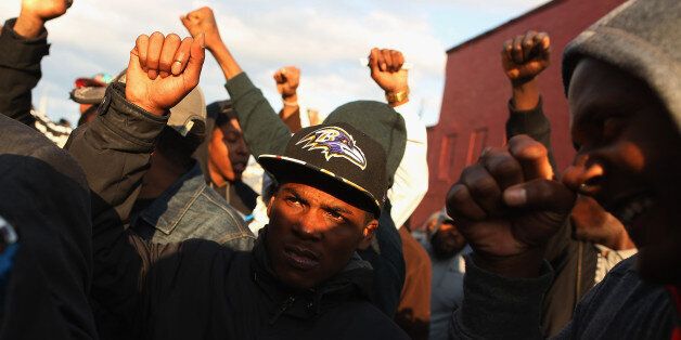 BALTIMORE, MD - APRIL 22: Demonstrators put their fists in the air as a sign of 'black power' during a protest against police brutality and the death of Freddie Gray outside the Baltimore Police Western District station in the Sandtown neighborhood April 22, 2015 in Baltimore, Maryland. Gray, 25, was arrested for possessing a switch blade knife April 12 outside the Gilmor Homes housing project on Baltimore's west side. According to his attorney, Gray died a week later in the hospital from a severe spinal cord injury he received while in police custody. (Photo by Chip Somodevilla/Getty Images)