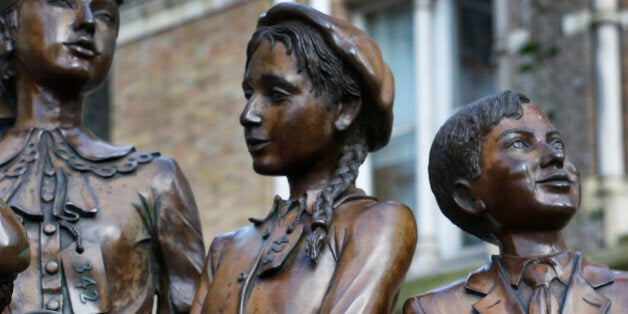This Thursday, Nov. 21, 2013 photo, shows a rose placed on a sculpture memorial outside Liverpool Street Station in London. T