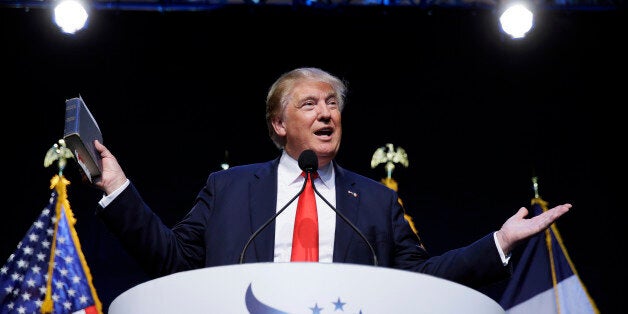 FILE - In this Sept. 19, 2015 file photo, Republican presidential candidate, businessman Donald Trump holds a Bible as he speaks during the Iowa Faith & Freedom Coalition's annual fall dinner in Des Moines, Iowa. Producers at CBS are making four separate episodes of "60 Minutes" for Sunday, trying to fit in three stories, including an interview with Trump. Scott Pelley will press Trump for specifics on issues like taxes, education, defense and immigration. (AP Photo/Charlie Neibergall, File)