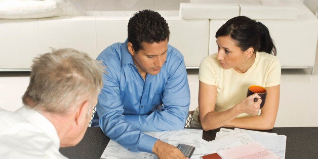 Businessman Assisting Couple with Credit Cards