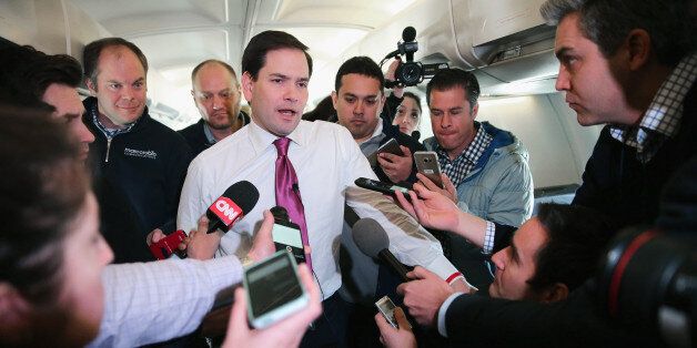 IN FLIGHT - FEBRUARY 10: Republican presidential candidate Sen. Marco Rubio (R-FL) talks with reporters on his charter flight from Manchester-Boston Regional Airport February 10, 2016 en route to Spartanburg, South Carolina. Rubio placed fifth in the New Hampshire primary, behind fellow GOP candidates Jeb Bush, John Kasich, Sen. Ted Cruz (R-TX) and Donald Trump, who swept away the competition with 35-percent of the vote. (Photo by Chip Somodevilla/Getty Images)