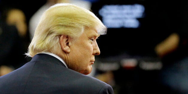 Republican presidential candidate, businessman Donald Trump pauses in the Spin Room after a Republican presidential primary debate at The University of Houston, Thursday, Feb. 25, 2016, in Houston. (AP Photo/David J. Phillip)