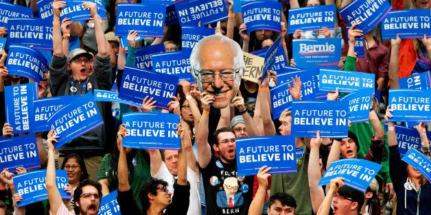Students and supporters of Democratic presidential candidate Sen. Bernie Sanders, I-Vt., cheer and hold up signs, including one of Sanders, during a campaign rally at Colorado State University in Fort Collins, Colo., Sunday, Feb. 28, 2016. (AP Photo/Jacquelyn Martin)