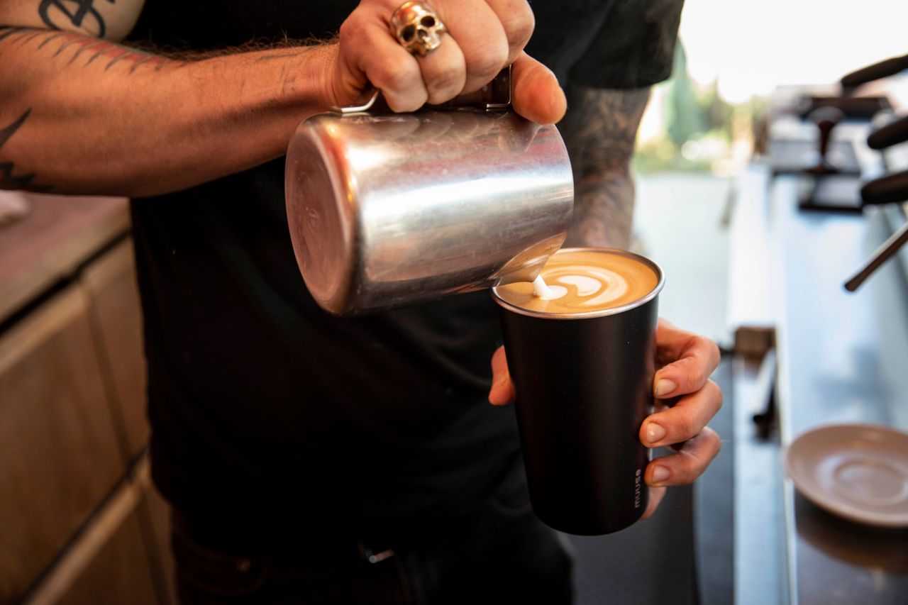 A barista at Ritual Coffee makes a latte in a reusable Muuse coffee cup. Ritual has been pilot testing the cups in its Hayes Valley location.