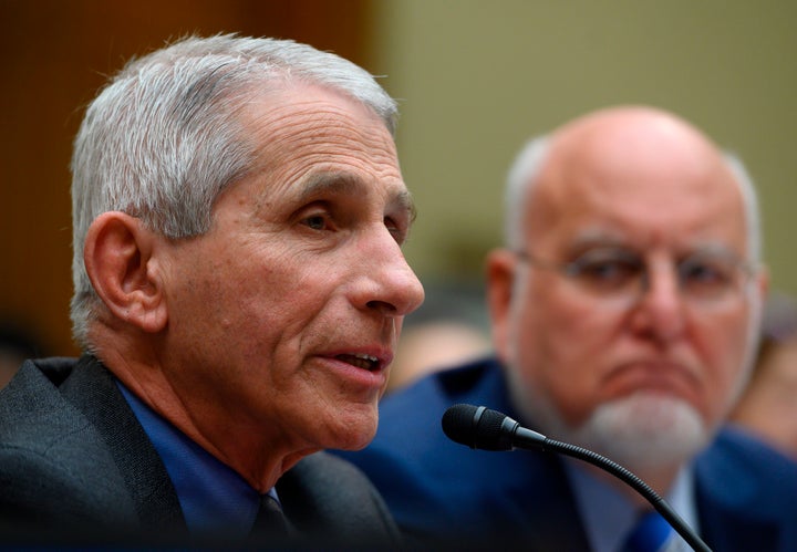 Dr. Anthony Fauci, director of the National Institute of Allergy and Infectious Diseases at the National Institutes of Health, and Dr. Robert Redfield, director of the Centers for Disease Control and Prevention, testify during a Wednesday hearing concerning the government's response to the coronavirus.