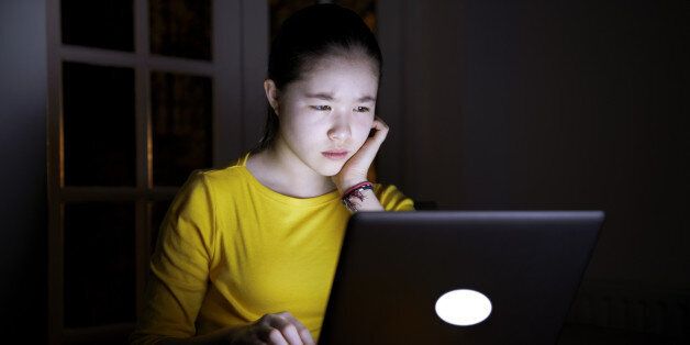 Serious teenager online late at night