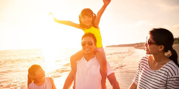 happy family walking on the beach