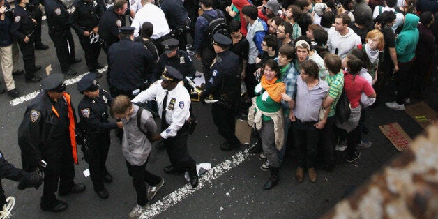 NEW YORK, NY - OCTOBER 01: Police arrest two demonstrators affiliated with the Occupy Wall Street movement after they attempted to cross the Brooklyn Bridge on the motorway on October 1, 2011 in New York City. This portion of the bridge is not intended for pedestrians and as the marchers attempted to cross, they were stopped midway by police. (Photo by Mario Tama/Getty Images)