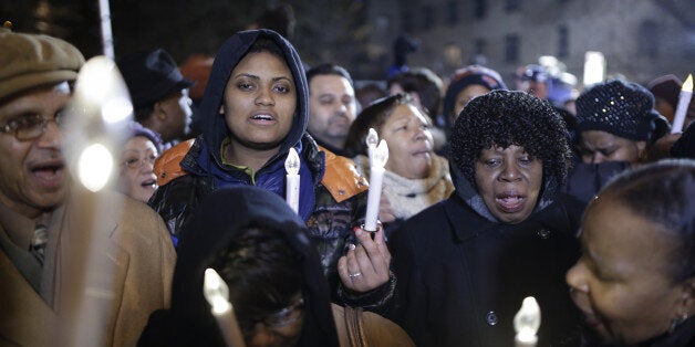 NEW YORK, NY - DECEMBER 21: People visit the memorial at the corner Tompkins Ave and Myrtle Ave on December 21, 2014 in New York near the site where two New York City police officers were shot dead in a patrol car on Saturday. Police officers Rafael Ramos and Wenjian Liu were sitting in a marked police car in front of 98 Tompkins Avenue in Bedford-Stuyvesant neighborhood of Brooklyn when the suspect, identified as 28-year-old Ismaaiyl Brinsley, shot them ambush-style, officials said. (Photo by Bilgin S. Sasmaz/Anadolu Agency/Getty Images)