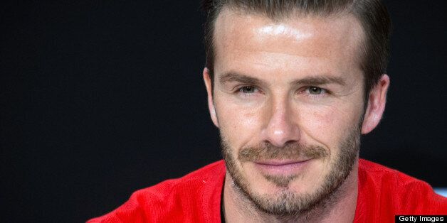 Paris Saint-Germain's football club English midfielder David Beckham waits for fans prior to sign autographs, at a Swedish multinational retail-clothing company H&M store in Paris, on May 24, 2013. AFP PHOTO / MARTIN BUREAU (Photo credit should read MARTIN BUREAU/AFP/Getty Images)