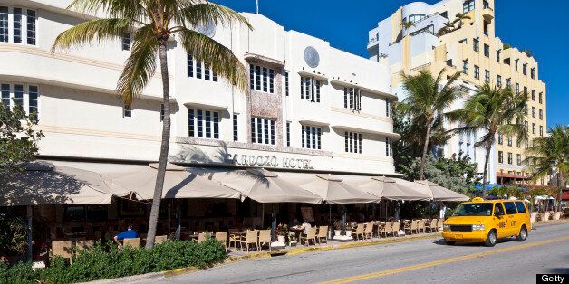 United States, Florida, Miami Beach, South Beach, Art Deco District, Ocean Drive, taxi in front of Cardozo hotel built in 1939 by architect Henry Hohauser