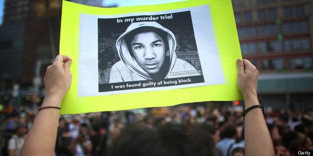NEW YORK, NY - JULY 14: A protester holds a sign at a rally honoring Trayvon Martin at Union Square in Manhattan on July 14, 2013 in New York City. George Zimmerman was acquitted of all charges in the shooting death of Martin July 13 and many protesters questioned the verdict. (Photo by Mario Tama/Getty Images)
