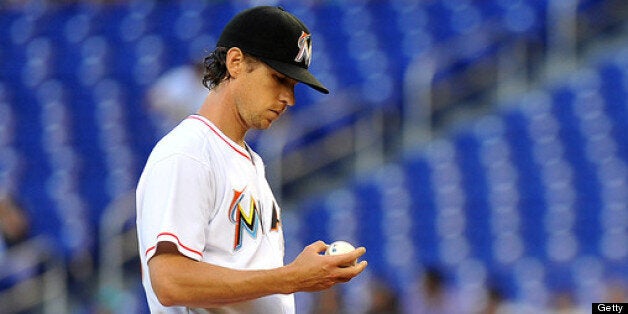 MIAMI, FL - JULY 8: Kevin Slowey #45 of the Miami Marlins examines the baseball on the pitching mound during the first inning