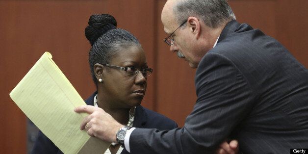 SANFORD, FL - JULY 05: Assistant state attorney Bernie de la Rionda talks to Sybrina Fulton, Trayvon Martin's mother, on the stand during a recess in George Zimmerman's trial in Seminole circuit court July 5, 2013 in Sanford, Florida. Zimmerman is charged with second-degree murder for the February 2012 shooting death of 17-year-old Trayvon Martin. (Photo by Gary W. Green-Pool/Getty Images)