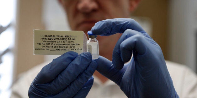 Professor Adrian Hill, Director leader of the trials for the experimental Ebola vaccine holds a vial of the vaccine in Oxford, England Wednesday Sept. 17, 2014. A former nurse will be the first of 60 healthy volunteers in the U.K. who will receive the vaccine. The vaccine was developed by the U.S. National Institutes of Health and GlaxoSmithKline and targets the Zaire strain of Ebola, the cause of the ongoing outbreak in West Africa. A trial of the same vaccine has already begun in the U.S. (AP Photo/Steve Parsons/Pool)