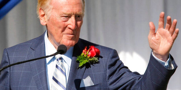 Hall of Fame broadcaster Vin Scully waves to the media after being introduced as the grand marshall for 125th Tournament of Roses parade at Tournament House in Pasadena, Calif. on Thursday, Sept 5, 2013. Scully will serve as grand marshal of the 125th Rose Parade on New Year's Day in Pasadena on Jan. 1, 2014. (AP Photo/Nick Ut)