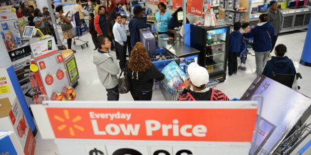 People shop at a Walmart in the Crenshaw district of Los Angeles on Black Friday, November 29, 2013. US stocks Friday moved higher in a holiday-shortened session following better eurozone economic data and positive early assessments of 'Black Friday' shopping traffic by some leading retailers. AFP PHOTO / Robyn Beck (Photo credit should read ROBYN BECK/AFP/Getty Images)