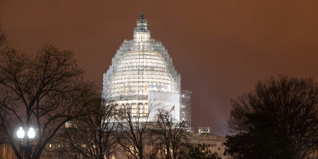 The U.S. Capitol in Washington is seen Wednesday evening, Jan. 14, 2015. A man who plotted to attack the U.S. congressional building and kill government officials inside it and spoke of his desire to support the Islamic State group was arrested on Wednesday, the FBI said. A criminal complaint filed in U.S. District Court in Ohio charges Christopher Lee Cornell with attempting to kill officers and employees of the United States. The Capitol Dome is covered with scaffolding for a long-term repair project. (AP Photo/J. Scott Applewhite)