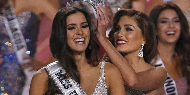 Reigning Miss Universe Gabriela Isler, right, crowns the new Miss Universe, Paulina Vega of Colombia, left, during the Miss Universe pageant in Miami, Sunday, Jan. 25, 2015. (AP Photo/Wilfredo Lee)
