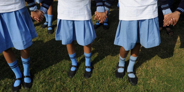 Indian school children hold hands as they make a human chain during a function to mark World Toilet Day in New Delhi on November 18, 2012. According to the 2011 census, about 131 million households in India have no latrine in their premises, with eight million using public facilities and 123 million defecating in the open. AFP PHOTO/SAJJAD HUSSAIN (Photo credit should read SAJJAD HUSSAIN/AFP/Getty Images)