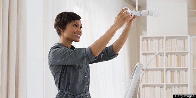 Woman fitting lightbulb