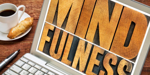 mindfulness word typography - isolated text in letterpress wood type on a laptop screen - spiritual concept