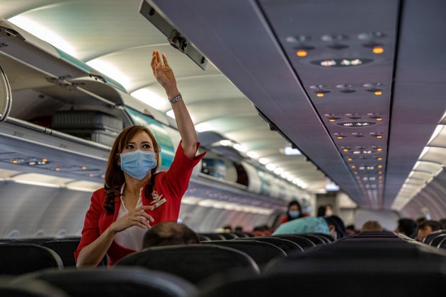 INCHEON, SOUTH KOREA - MARCH 10: A flight attendant is seen wearing a facemask aboard an AirAsia flight bound for Manila, Philippines, at Incheon International Airport on March 10, 2020 in Incheon, South Korea. According to the Korea Centers for Disease Control and Prevention, 131 new cases have been reported, with the death toll rising to 54. The total number of infections in the nation tallies at 7,513. (Photo by Ezra Acayan/Getty Images)