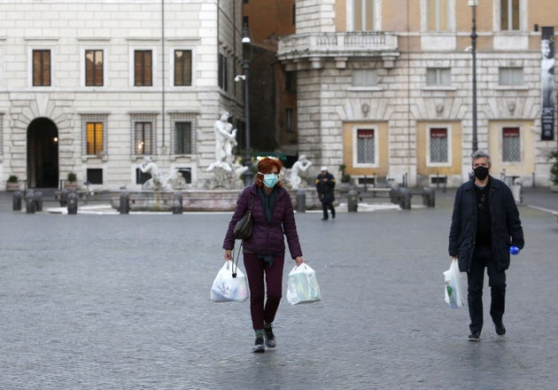ROME, ITALY - MARCH 11: People wear protective masks in the Piazza Navona in Rome, Italy, on March 11, 2020. Italian government has extended restrictions which was previously limited in the northern Italy, to countrywide with an aim of the Covid-19 outbreak prevention.