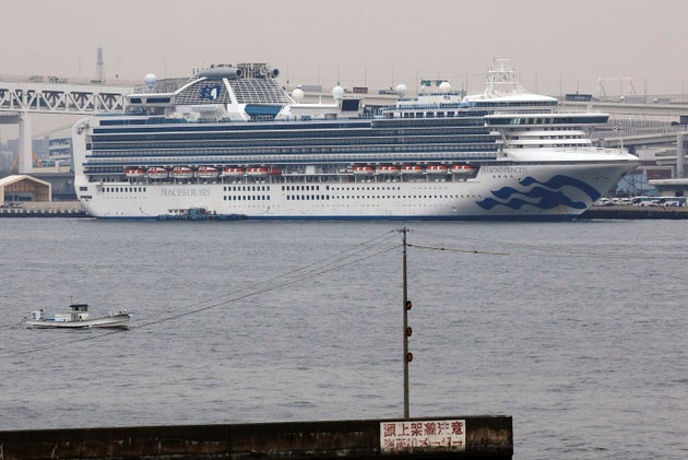 The Diamond Princess cruise ship is anchored at a port in Yokohama, Tuesday, Feb. 25, 2020. Japanese health officials and experts on a government panel acknowledged Monday that the quarantine of the virus-hit cruise ship was not perfect, but defended Japan's decision to release about 1,000 passengers after 14 days. (Kyodo News via AP)