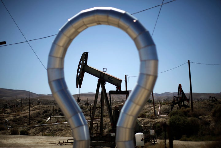 Pump jacks swing in the Midway Sunset oilfield in California, near a large shale formation. 