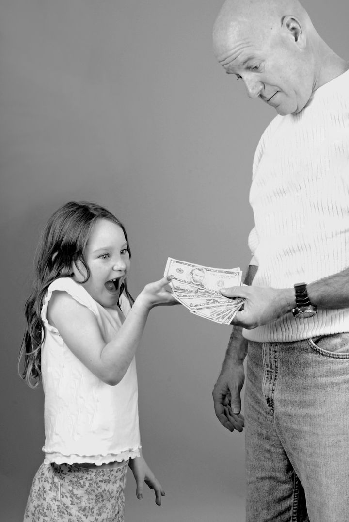 Father Giving Elated Daughter Spending Money