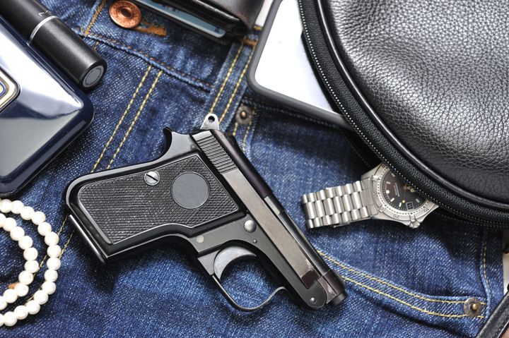 a woman's purse and gun and...