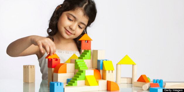 Girl (4-5) playing with building blocks