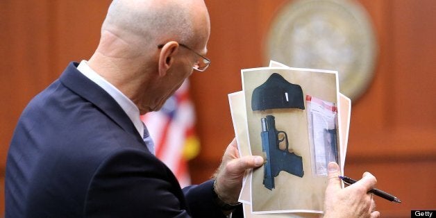 Don West, a defense attorney for George Zimmerman, describing the shooting of Trayvon Martin to the jury, holds the evidence photo of the gun during opening arguments in Seminole circuit court, on the 11th day of Zimmerman's trial, in Sanford, Florida, Monday, June 24, 2013. Zimmerman is accused in the fatal shooting of Trayvon Martin. (Joe Burbank/Orlando Sentinel/MCT via Getty Images)