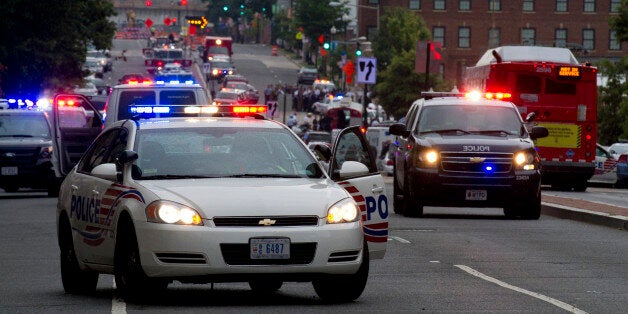 UNITED STATES - Sept 16: Police and firefighters in the background responded to the report of a shooting at the Navy Yard in Washington, DC, September 16, 2013. A gunman shot and wounded at least 12 people at the headquarters building at the US Navy Yard. (Photo By Douglas Graham/CQ Roll Call)