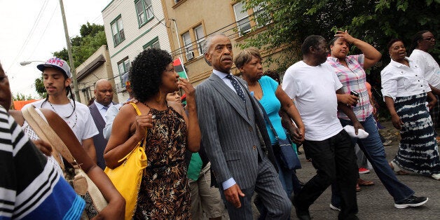 NEW YORK, NY - JULY 19: The Rev. Al Sharpton marches with family members of Eric Garner (right) and hundreds of others during a demonstration against the death of Eric Garner after he was taken into police custody in Staten Island on Thursday on July 19, 2014 in New York City. New York Mayor Bill de Blasio announced in a news conference yesterday that there will be a full investigation into the circumstances surrounding the death of Garner. The 400-pound, 6-foot-4 asthmatic, Garner (43) died after police put him in a chokehold outside of a convenience store for illegally selling cigarettes. (Photo by Spencer Platt/Getty Images)