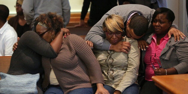 The family/supporters of Dushawn Taylor-Gennis, including his mother Genneane Gennis, seated second from right, react at the