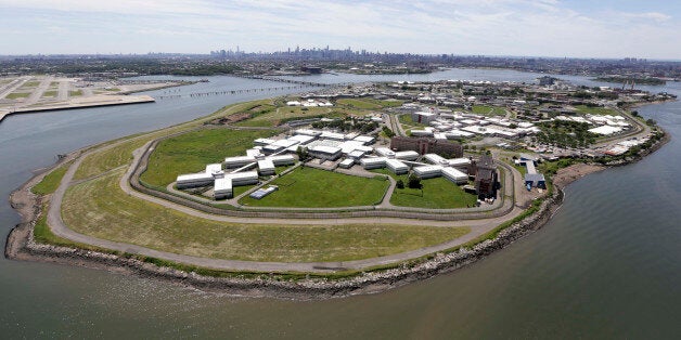 File-This June 20, 2014, file photo shows New York's biggest lockup, Riker's Island jail, with the New York skyline in the background. A New York City jail guard accused of ignoring the pleas of a dying mentally ill inmate at Rikers Island in 2012 is set to go on trial. Jury selection begins Monday in Manhattan federal court for Terrence Pendergrass, who is charged with violating the rights of 25-year-old Jason Echevarria. Authorities say Pendergrass ignored other guardsâ warnings that Echevarria was in agonizing pain, vomiting and spitting up blood after ingesting a toxic soap ball. They say Pendergrass peered into Echevarriaâs cell in a solitary confinement unit for mentally ill inmates before walking away. Pendergrass has pleaded not guilty. Echevarriaâs father has filed a $20 million lawsuit. Rikers has come under increased scrutiny for the way mentally ill inmates are treated. (AP Photo/Seth Wenig, File)