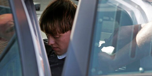 Charleston, S.C., shooting suspect Dylann Storm Roof sits inside a police car as he is escorted from the Sheby Police Department in Shelby, N.C., Thursday, June 18, 2015. (AP Photo/Chuck Burton)